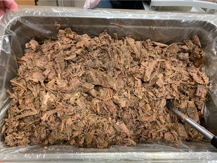 beef roast being made into barbecue beef